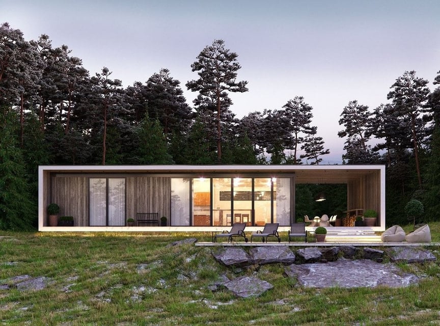 Vivienda de líneas horizontales revestida en madera, con galería abierta al bosque al atardecer
